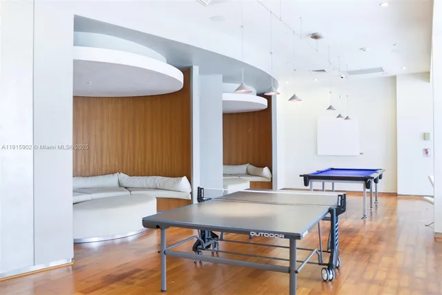 a living room with table and chairs