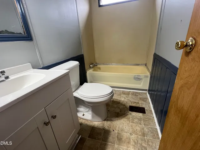 a bathroom with a toilet and a bathtub