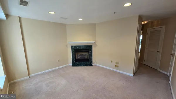 a view of an empty room with a fireplace