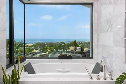 a living room with furniture a rug and a large window