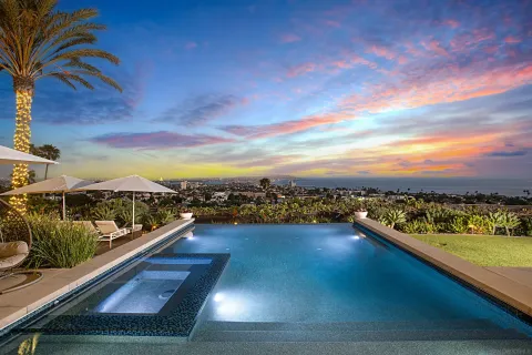 a view of a swimming pool with a table and chairs