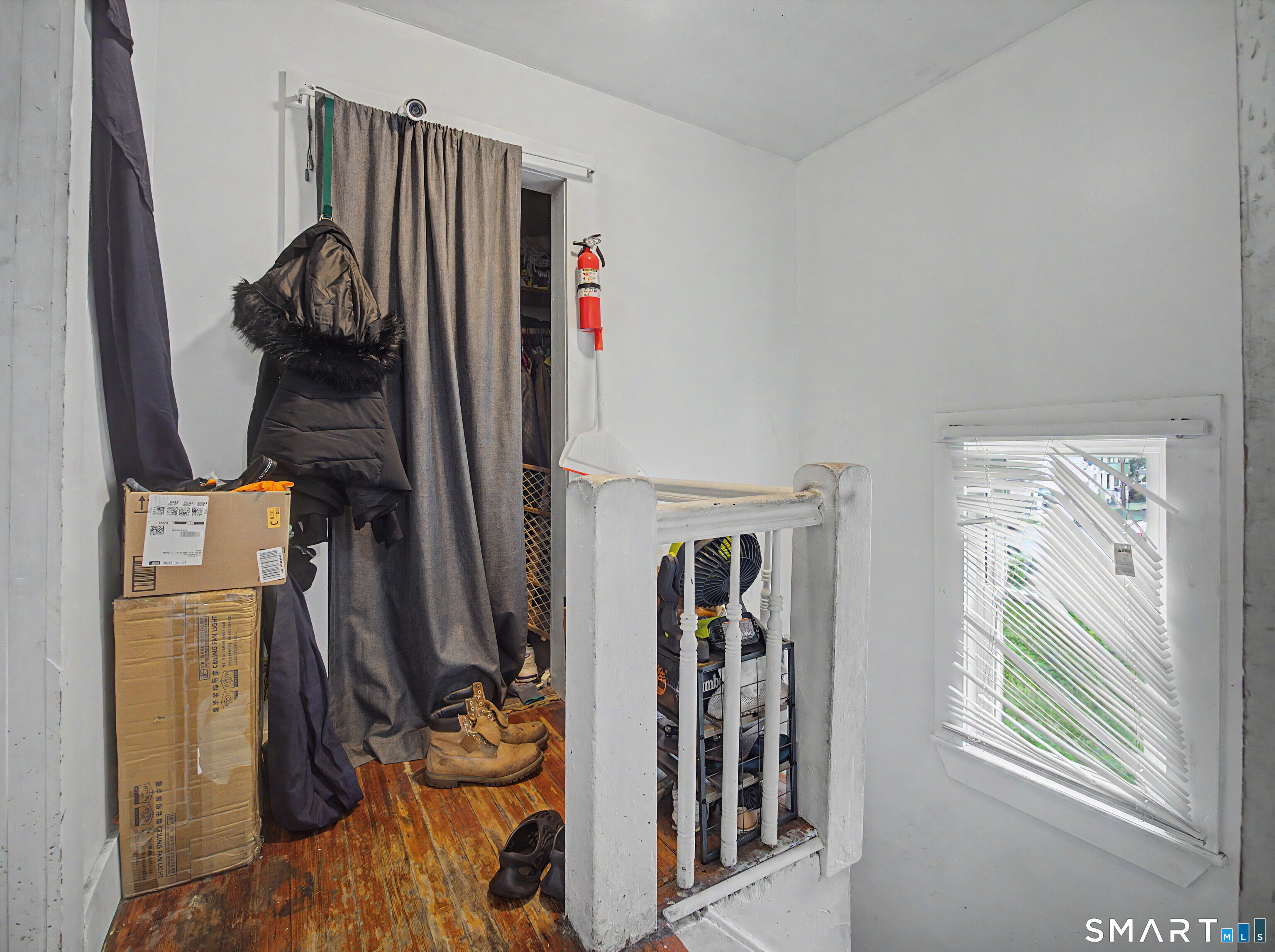 319 Carroll Avenue Bridgeport, CT 06607 - Photo 20 of 40 a view of walk in closet with clothes and shoes