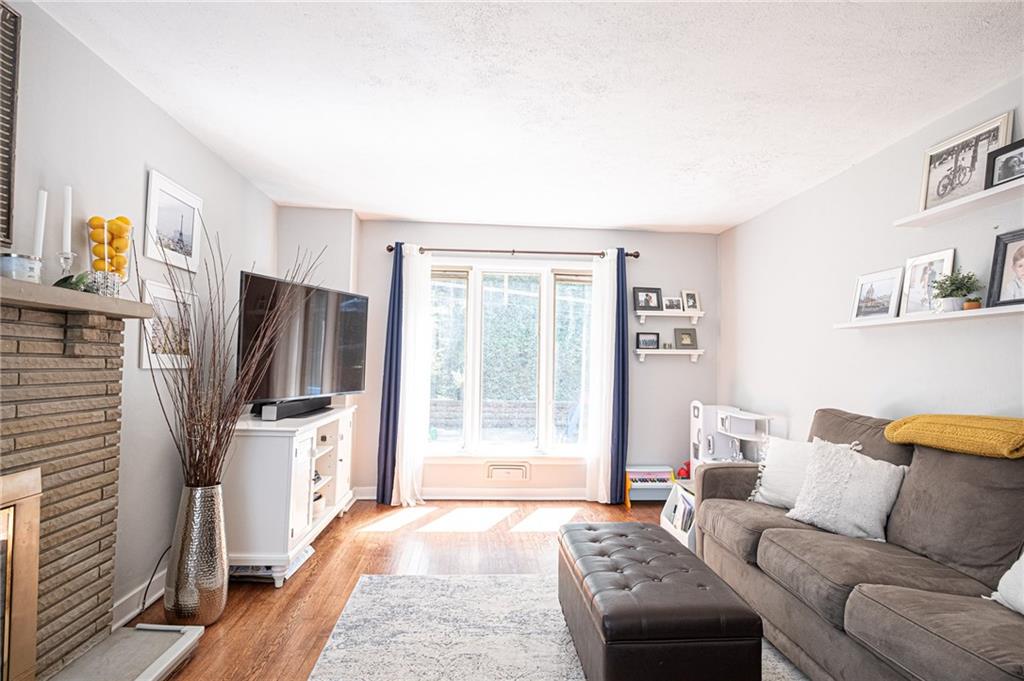 LIVING ROOM: Spacious living room, full of natural light and featuring neutral colors.