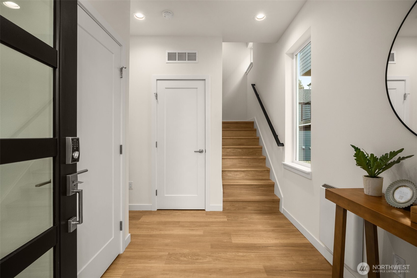 3914 South Juneau Street Seattle, WA 98118 - Photo 2 of 32 a view of a hallway with wooden floor and entryway