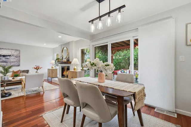 a view of a dining room with furniture window and wooden floor