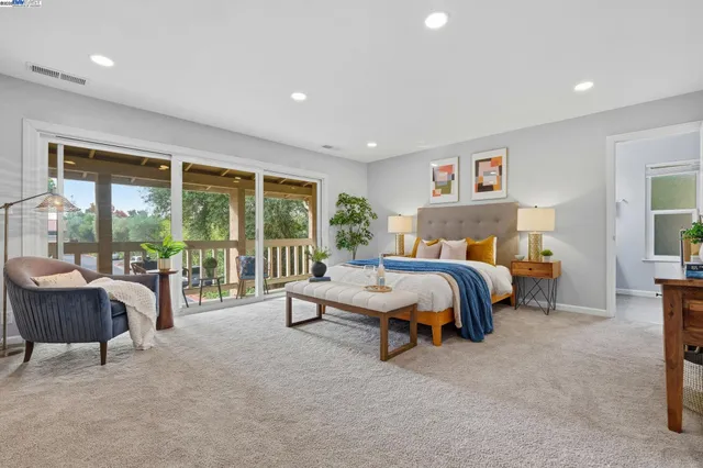 a spacious bedroom with a bed and a large window