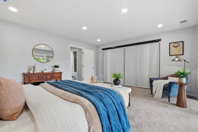 a bedroom with bed and a window