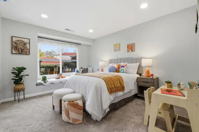 a bedroom with a bed and a couch