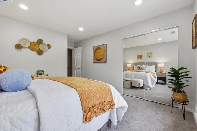 a bedroom with a bed and a couch