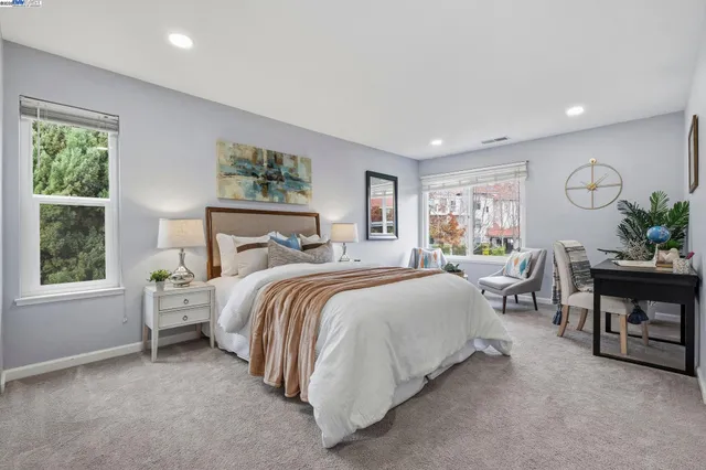 a spacious bedroom with a bed and a window