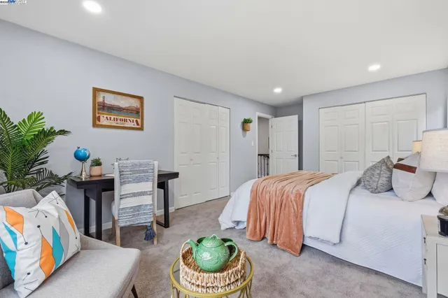 a bedroom with a bed and a couch