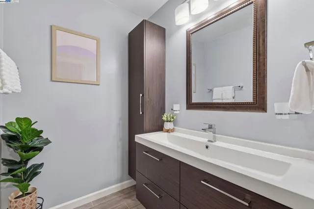 a bathroom with a sink a vanity and a mirror