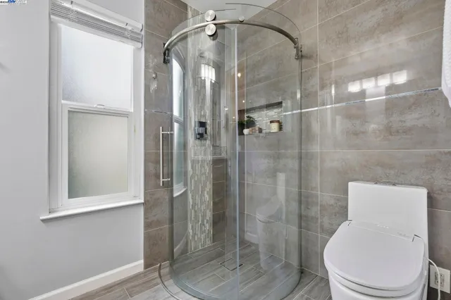 a bathroom with a toilet and shower