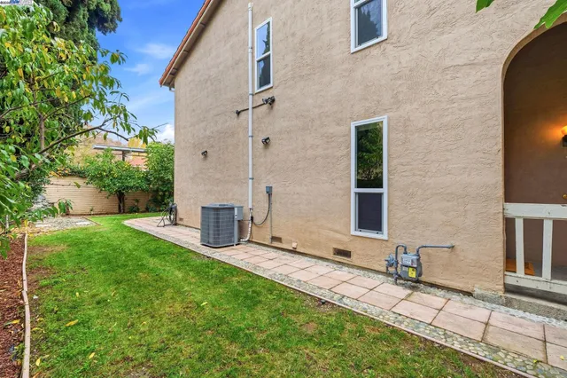 a view of a house with a yard and pathway