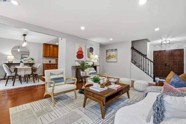 a living room with furniture and wooden floor