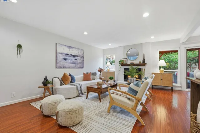 a living room with fireplace furniture and a wooden floor