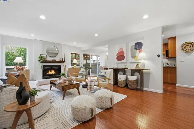 a living room with furniture and a fireplace