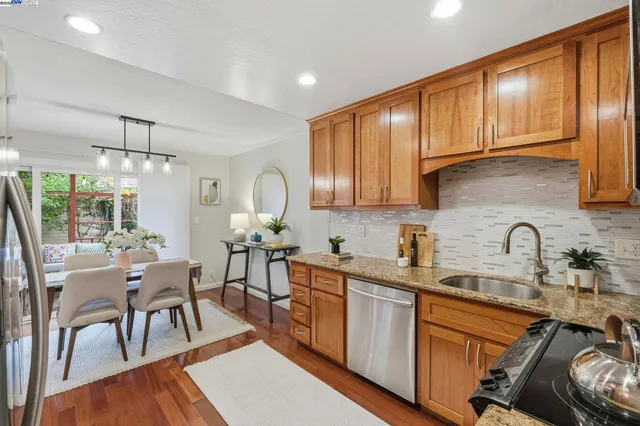 a kitchen with sink cabinets and dining table chair