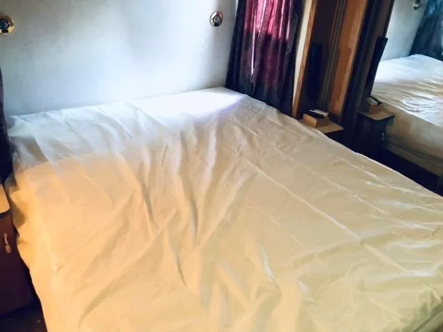 a bedroom with a bed and a mirror