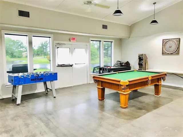 a living room with furniture table and a large window