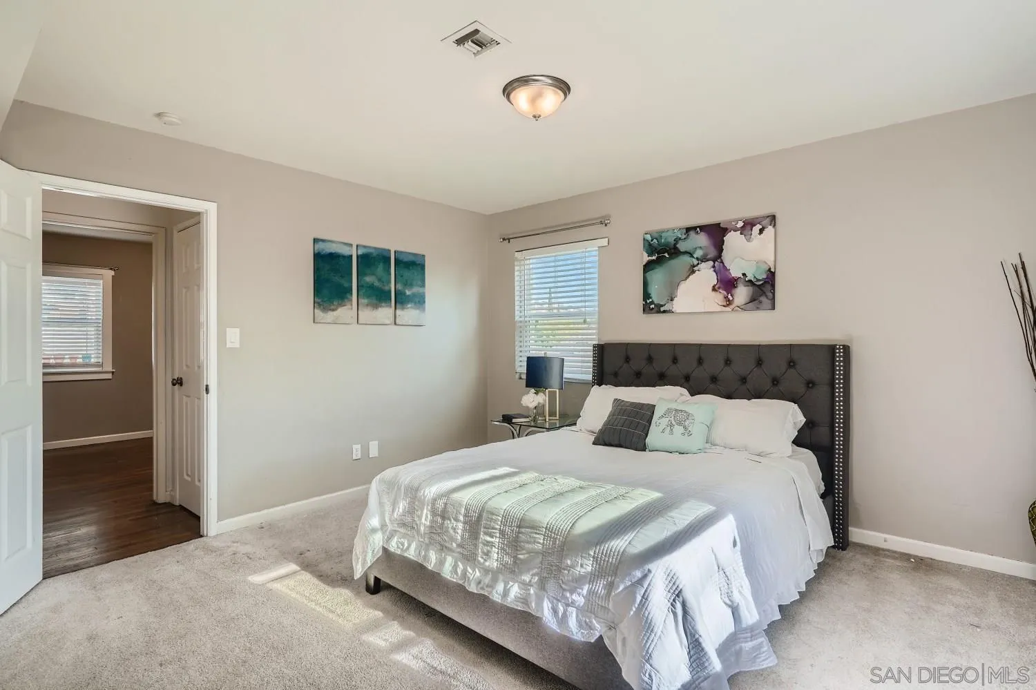 4817 Maple Avenue La Mesa, CA 91942 - Photo 19 of 31 a bedroom with a large bed and a painting on the wall