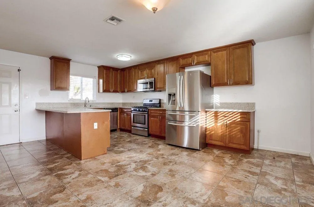 4817 Maple Avenue La Mesa, CA 91942 - Photo 31 of 31 a kitchen with stainless steel appliances granite countertop a stove sink and cabinets
