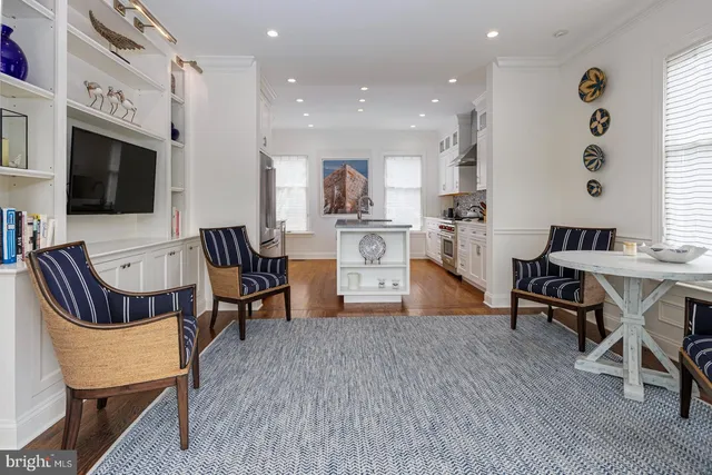 a living room with fireplace furniture and a flat screen tv