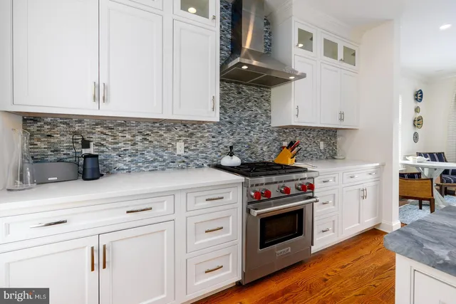 a kitchen with stainless steel appliances a stove and cabinets