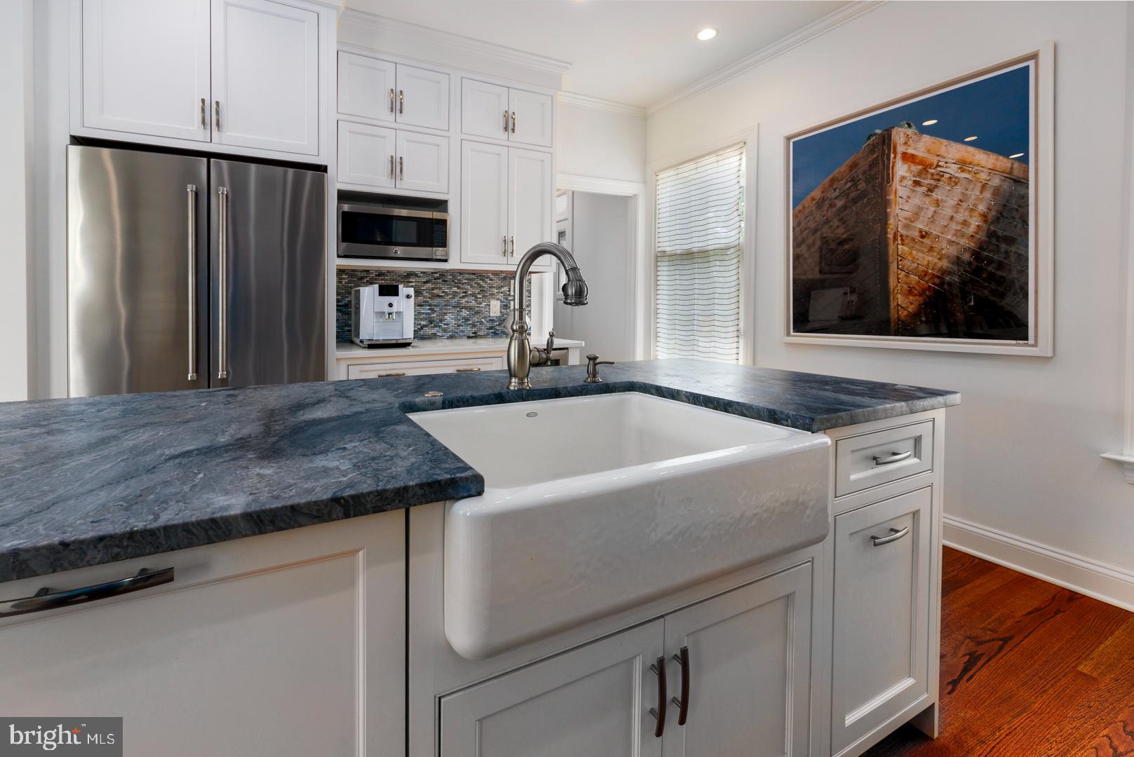222 East Chestnut Street St. Michaels, MD 21663 - Photo 18 of 38 a kitchen with granite countertop a refrigerator and a stove top oven