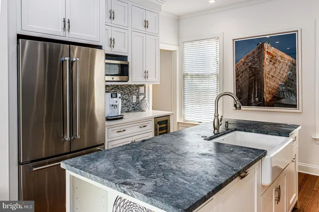 a kitchen with stainless steel appliances granite countertop a refrigerator and a sink