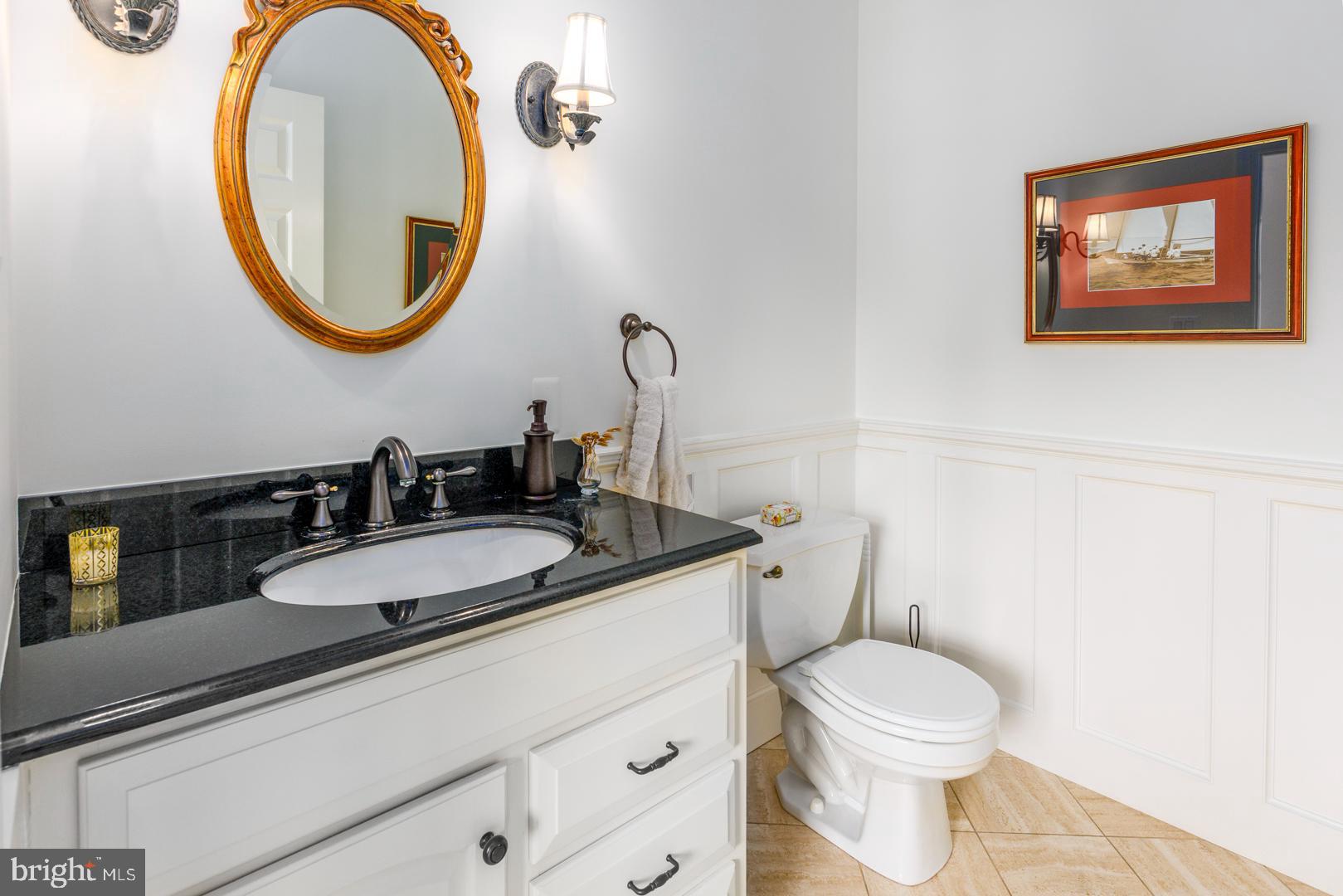 222 East Chestnut Street St. Michaels, MD 21663 - Photo 21 of 38 a bathroom with a toilet a sink and a mirror
