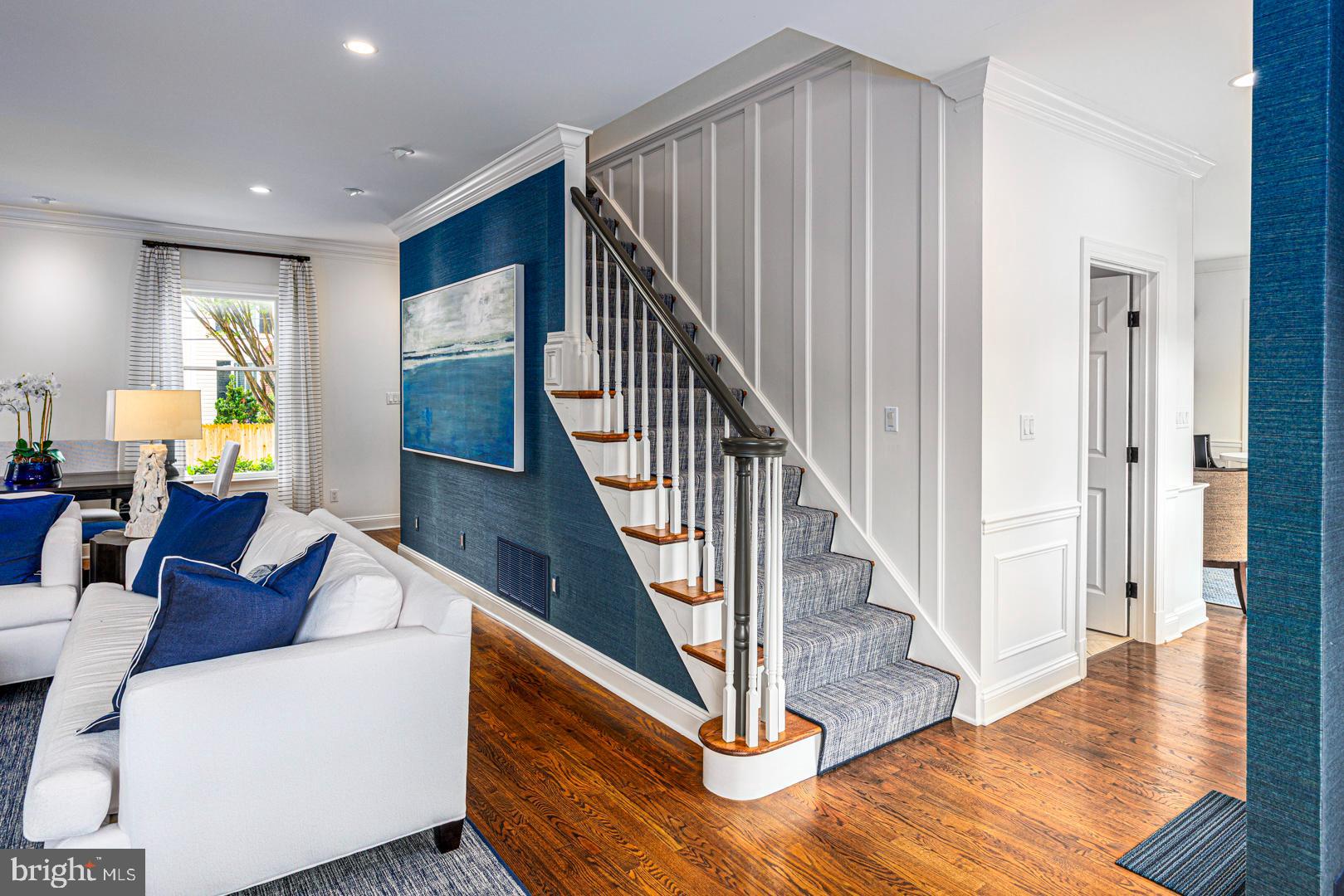 222 East Chestnut Street St. Michaels, MD 21663 - Photo 22 of 38 a living room with furniture and wooden floor next to a window
