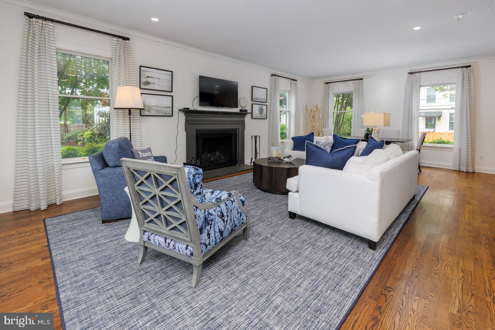 222 East Chestnut Street St. Michaels, MD 21663 - Photo 24 of 38 a living room with furniture a flat screen tv and a fireplace