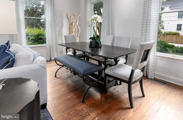 a living room with furniture wooden floor and a potted plant