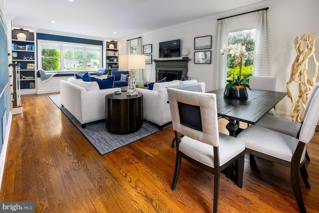 a living room with furniture a window and a flat screen tv