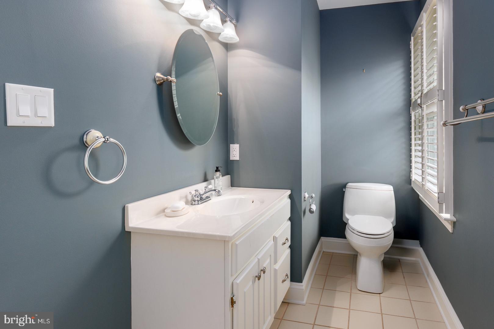222 East Chestnut Street St. Michaels, MD 21663 - Photo 28 of 38 a bathroom with a toilet sink and mirror