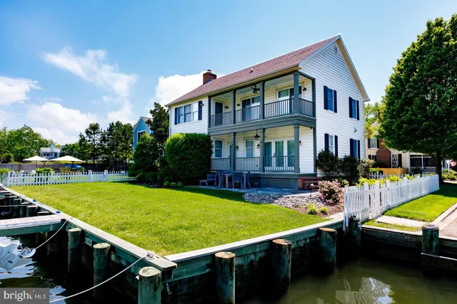 a view of a house with swimming pool and sitting area