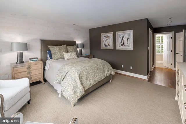 a bedroom with a bed and a night stand