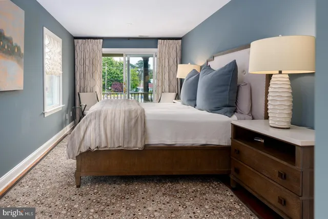 a bedroom with a bed chair and window