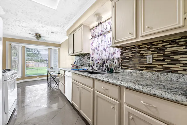 a kitchen with sink and cabinets
