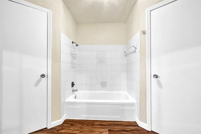 a bathroom with a bathtub and a shower