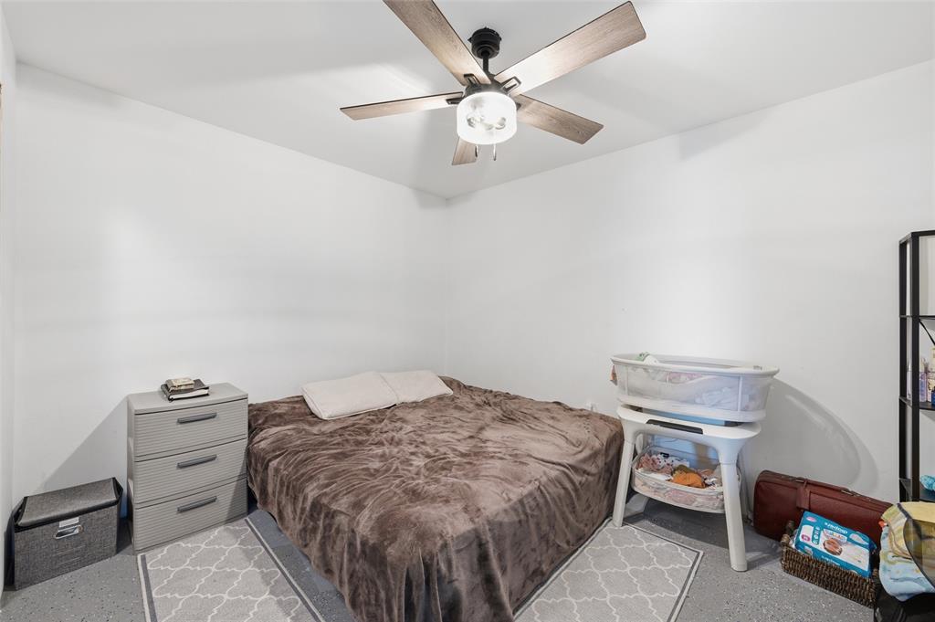 151 Kasberg Road Leroy, TX 76691 - Photo 31 of 40 a bedroom with a bed and a chandelier