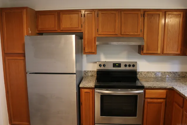 a kitchen with refrigerator stove and cabinets