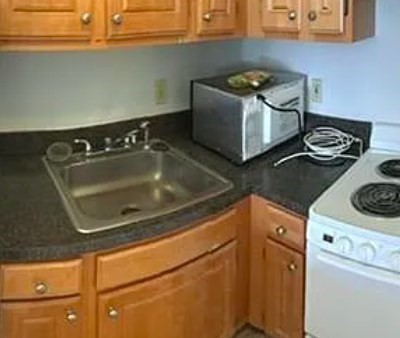 1025 Hancock Street, Unit 2K Quincy, MA 02169 - Photo 4 of 9 a kitchen with a stove and a sink