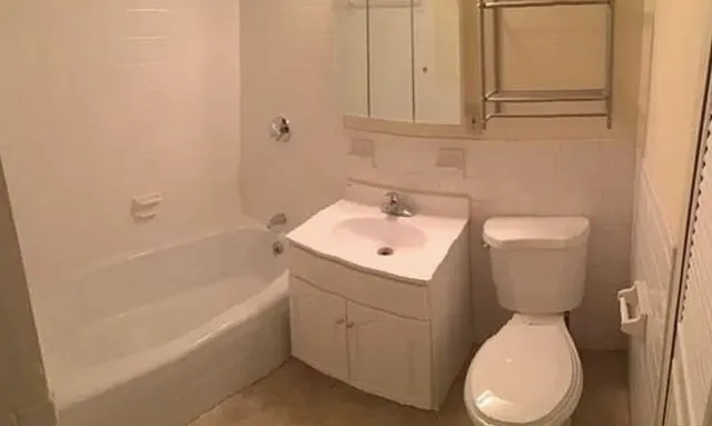 a bathroom with a sink a toilet and bathtub