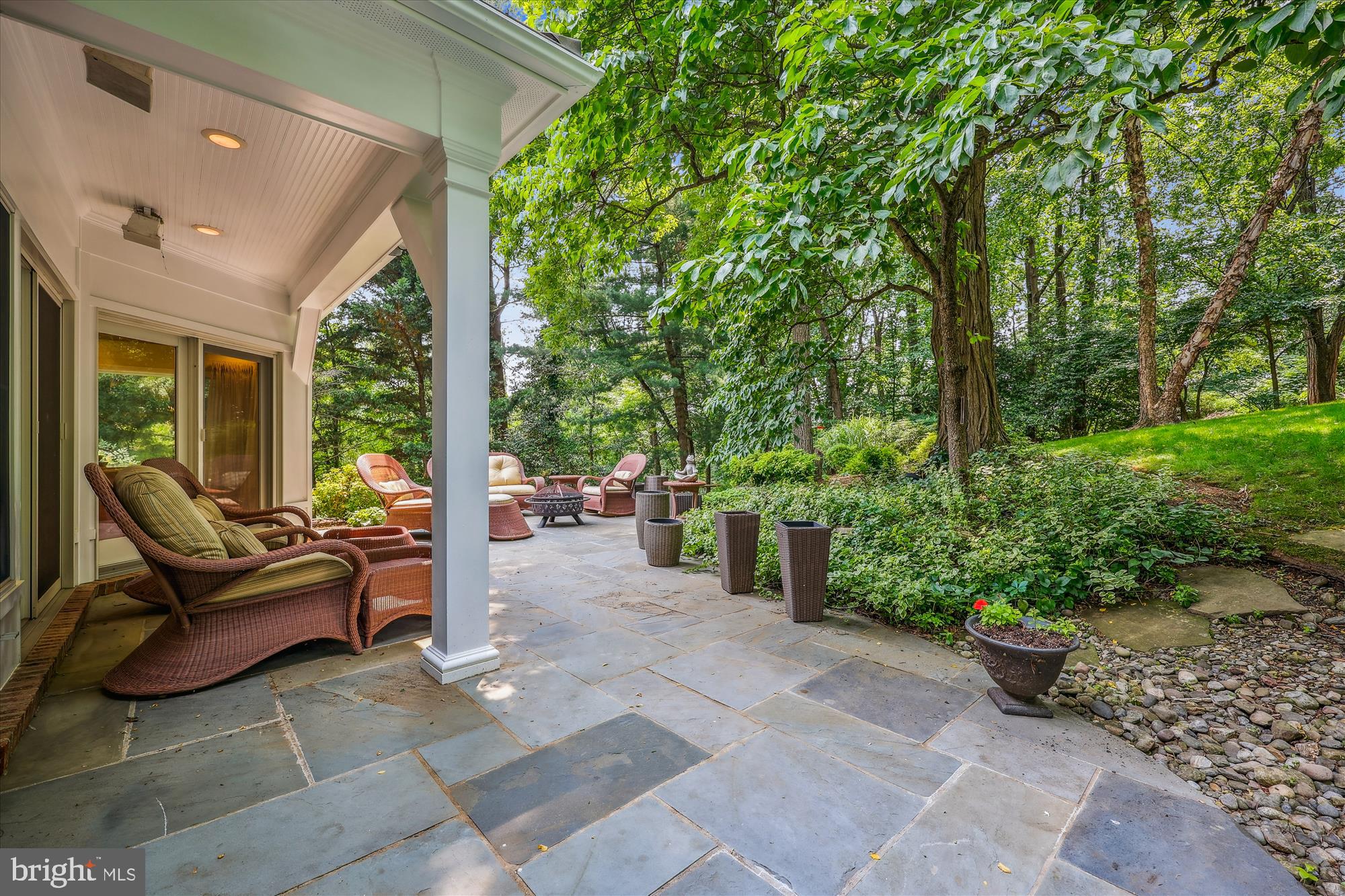 7212 Old Gate Road Rockville, MD 20852 - Photo 23 of 50 a view of a patio with table and chairs potted plants and large tree