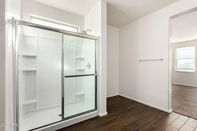 a bathroom with a glass shower door