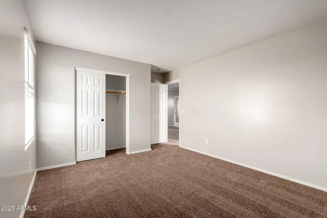 a view of an empty room and closet area