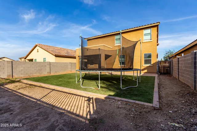 a backyard of a house with wooden fence