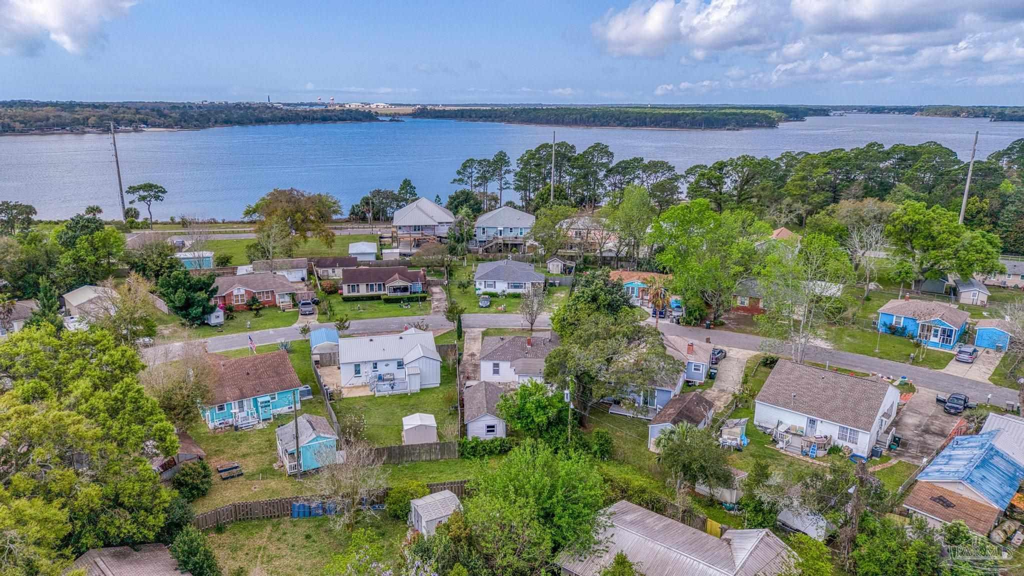 208 Berry Road Pensacola, FL 32507 - Photo 40 of 41 an aerial view of a house with a garden and lake view